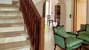 A staircase with wooden railings leading to a second floor.