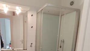 A modern bathroom with a glass-enclosed shower, a white sink, and a toilet. - Charming cottage in the heart of Saintes (Saintes)