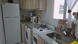 Fridge, microwave, coffee/tea maker, cookware/dishes/utensils