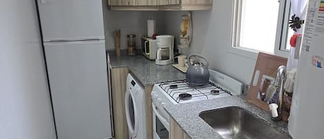 Fridge, microwave, coffee/tea maker, cookware/dishes/utensils
