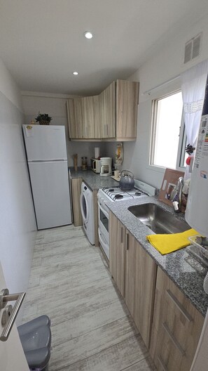 Fridge, microwave, coffee/tea maker, cookware/dishes/utensils