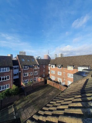 Residential area with terraced houses featuring pitched roofs and brick construction.