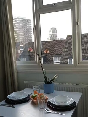 Enjoy a meal for two with a city view from this cozy dining area.
