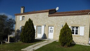 A stone house with a tiled roof, two symmetrical windows, and a central door. - Spacious Holiday Home in Monsegur With Pool (Monsegur)