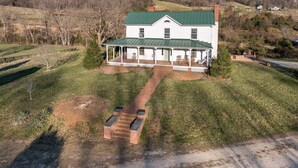 A two-story house with a green roof and a covered porch. - Branch and Barrel: Hot Tub & Sauna + Mtn Views (Roseland)