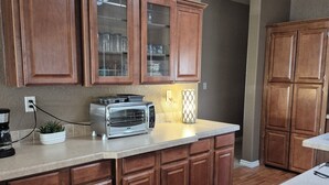 A kitchen with wooden cabinets, a built-in microwave, and a countertop.