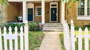 A two-story house with a front porch, a mailbox, and a small garden. - Spacious Historic home near 12 South with easy access to local attractions (Nashville)