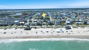 A coastal residential area with houses, a beach, and ocean views. - Brand New Oceanview 8bed/7.5 bath Hot Tub EV Charger (Surf City)
