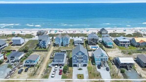 A coastal residential area with houses, a beach, and a clear view of the ocean. - Brand New Oceanview 8bed/7.5 bath Hot Tub EV Charger (Surf City)