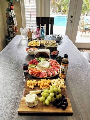 A table with a variety of food items and a bottle of sauce. - Your own Tropical Oasis with a fabulous pool 1 min from the beach (Cocoa Beach)