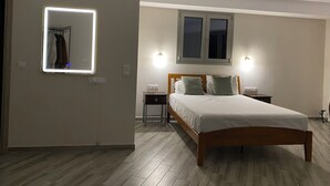 A bedroom with a bed, bedside tables, a mirror, and a window. - Vians Olympia Resort (Pyrgos)
