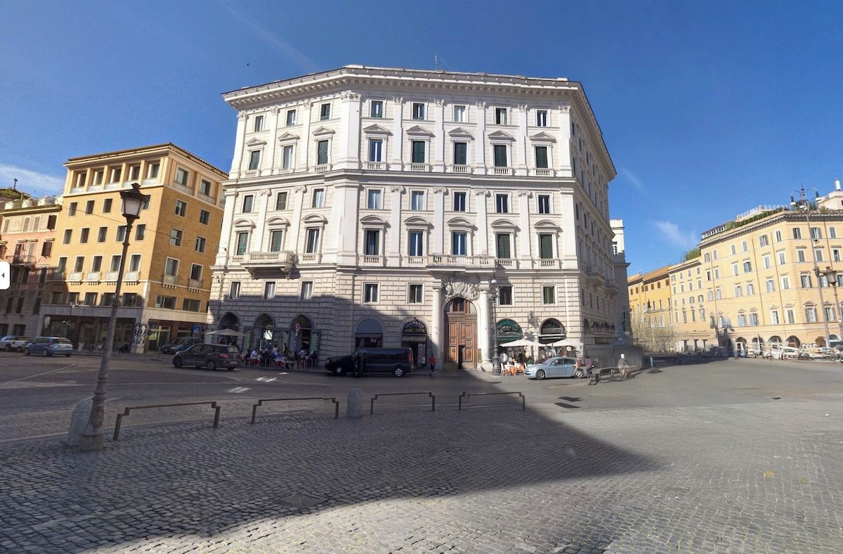 A historic building with a classical facade, large windows, and a central entrance.