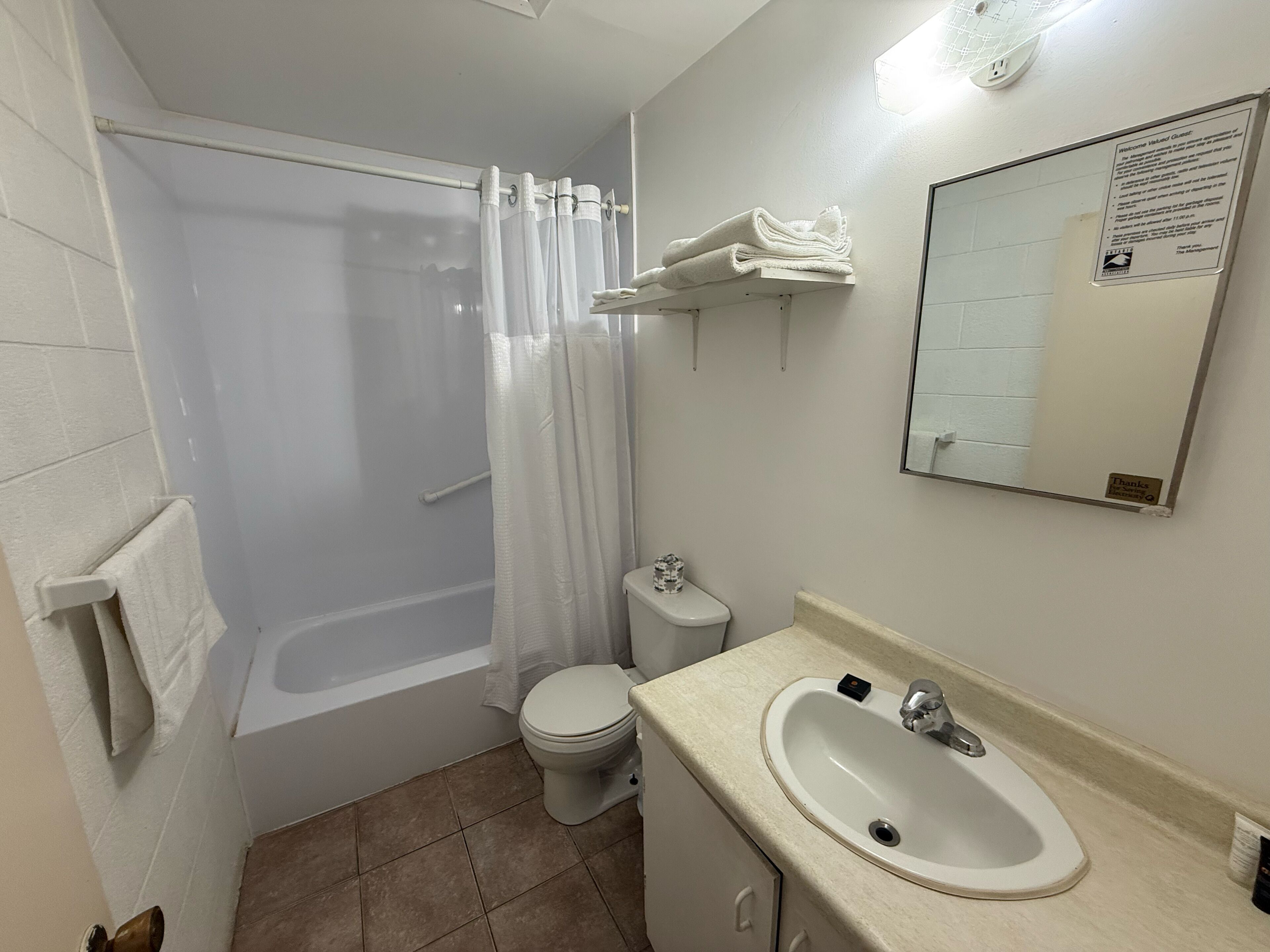A bathroom with a bathtub, toilet, and sink.