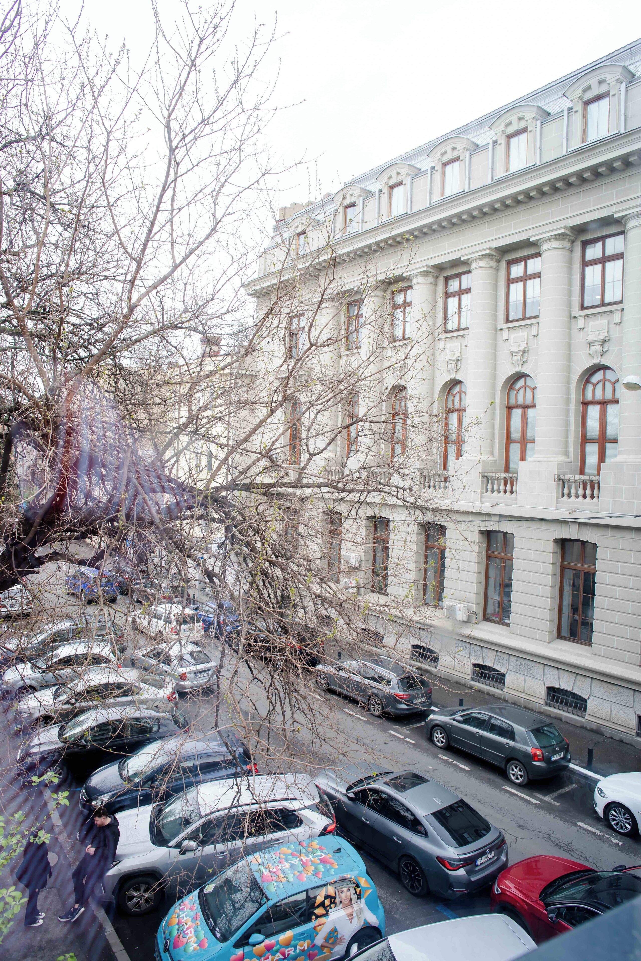 A multi-story building with a classical architectural style, featuring large windows and a symmetrical facade.