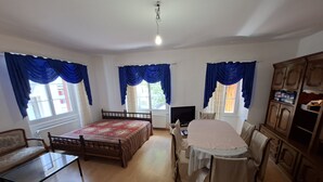 A room with a bed, a desk, a chair, a television, and a cabinet. - Ideal for hikers, artists and nature lovers (Waldenburg)
