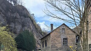 A rustic stone building with a traditional design, situated next to a clear water channel with terraced steps. - Ideal for hikers, artists and nature lovers (Waldenburg)