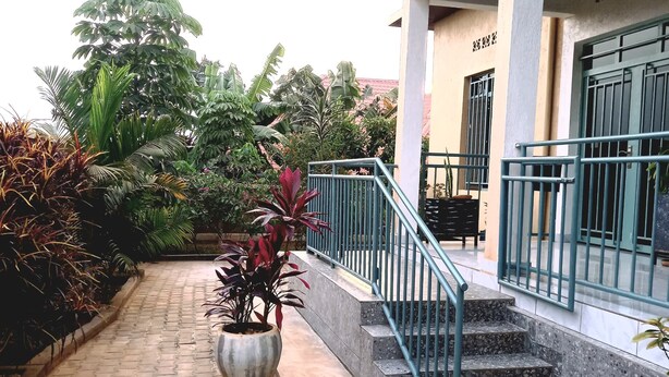 A paved pathway leading to a building with a staircase and a railing. - PEACE & QUIET CORNER (Kigali)