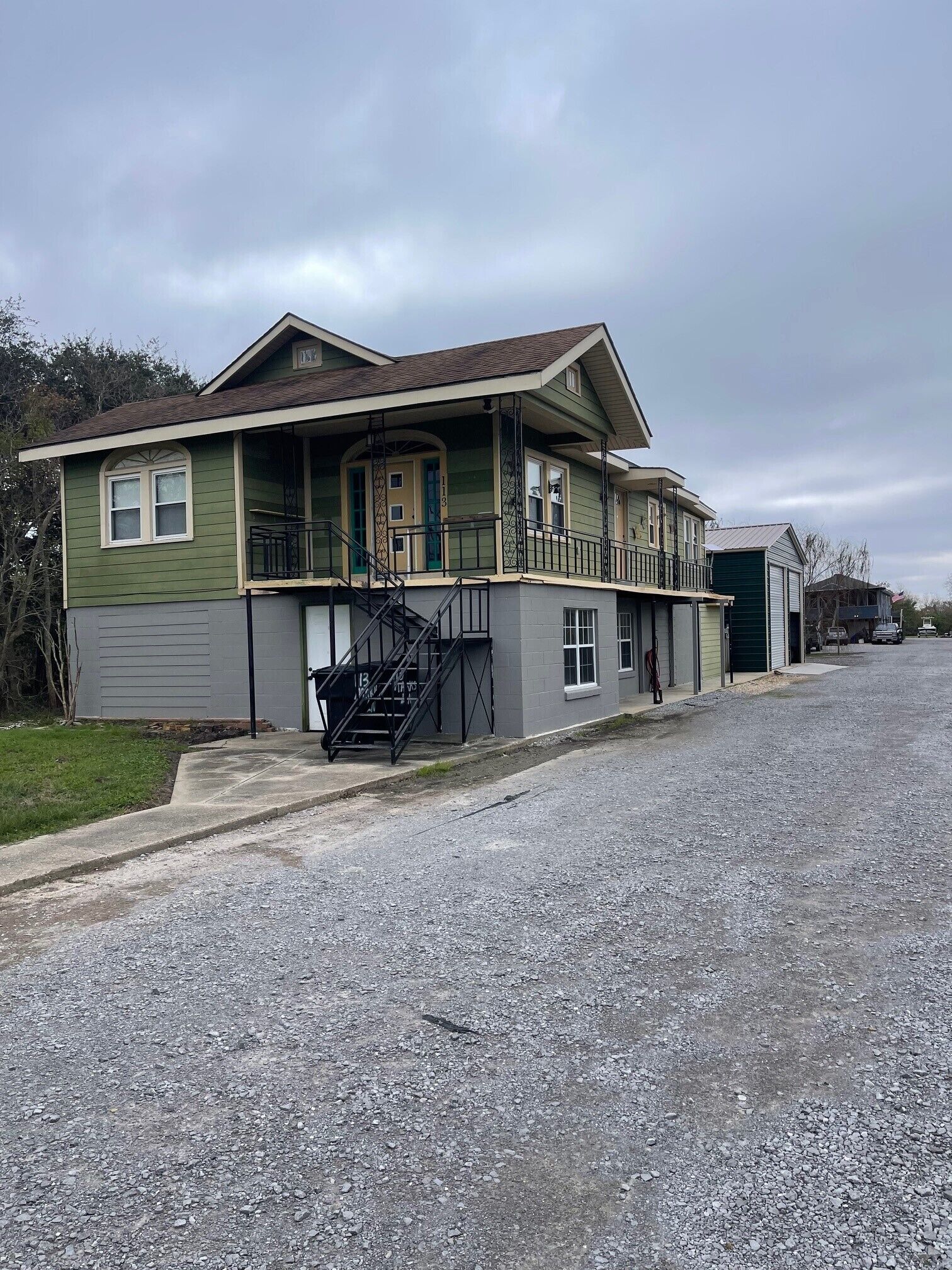 A two-story house with a front porch, a staircase, and a garage.