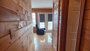 A wooden interior hallway with a door, a chair, and a window with blinds. - Cozy House/Cottage, minutes to National Park & Golf Course (York)