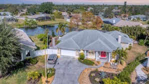A residential area with a house featuring a large driveway, a swimming pool, and a well-maintained lawn. - Luxury home NW Bradenton Fl (Bradenton)