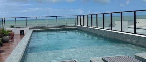 Enjoy a refreshing swim with a view of the calm sea from our rooftop pool.