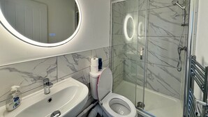 A modern bathroom with a toilet, sink, and shower. - Two Top Floor Double Rooms (Belvedere)