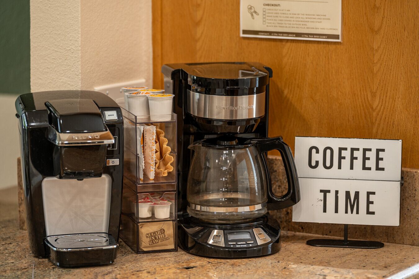 A coffee station with a coffee maker, a scale, and a sign indicating 'Coffee Time'.