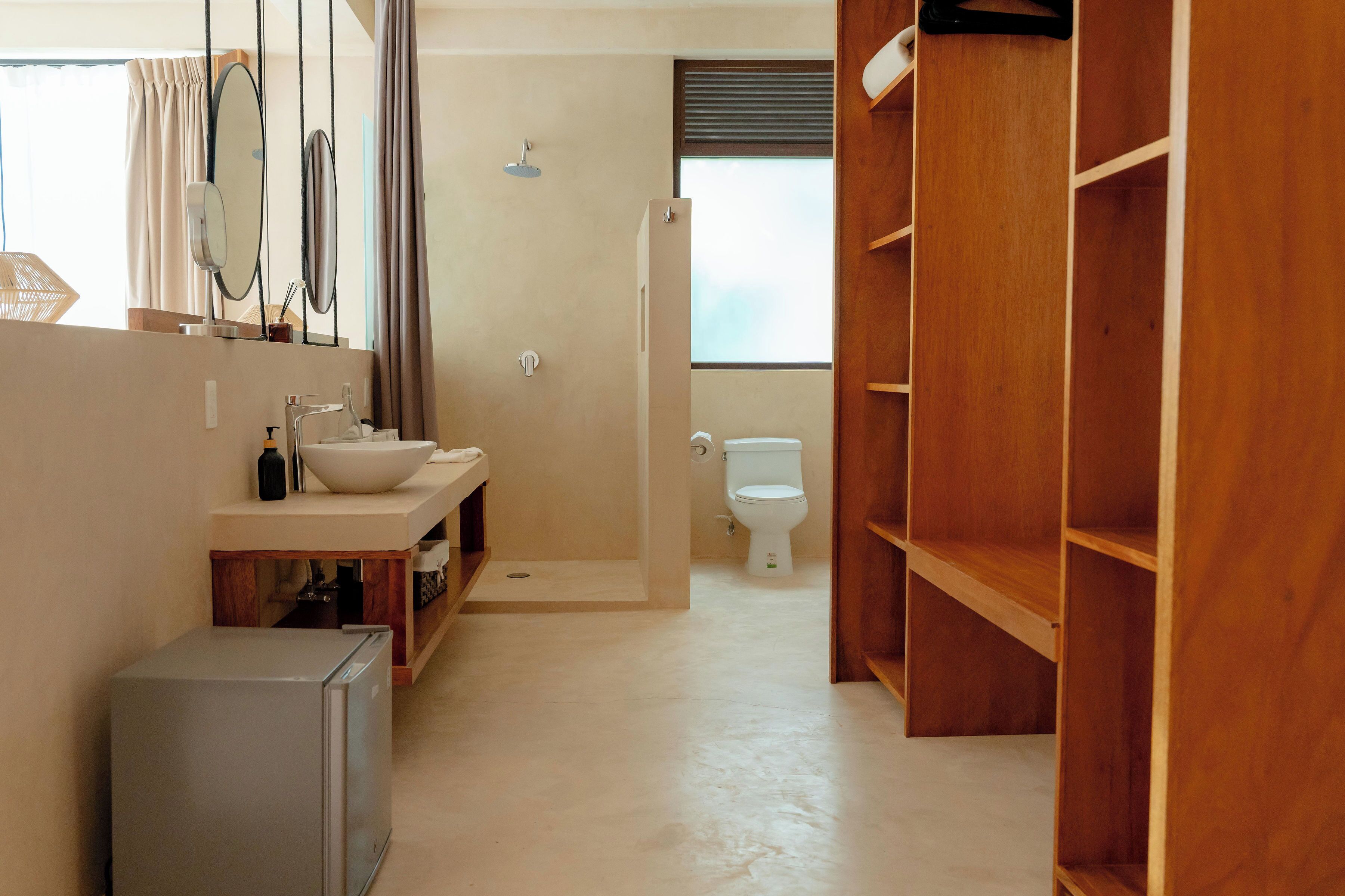 A bathroom with a sink, mirror, and toilet.