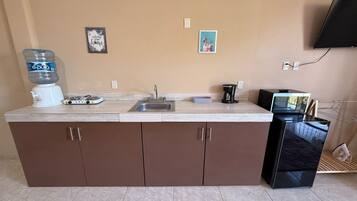 Microwave, stovetop, coffee/tea maker, cookware/dishes/utensils