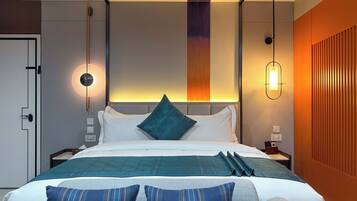 A modern hotel room with a neatly made bed, a headboard with a vertical light panel, and a wall-mounted light fixture.