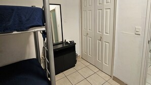 A room with a bunk bed, a dresser, a mirror, and a wardrobe with double doors. - Full house in subdivision (Juárez)