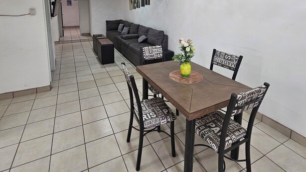A dining area with a table, chairs, a clock, and a wall with a recipe board. - Full house in subdivision (Juárez)