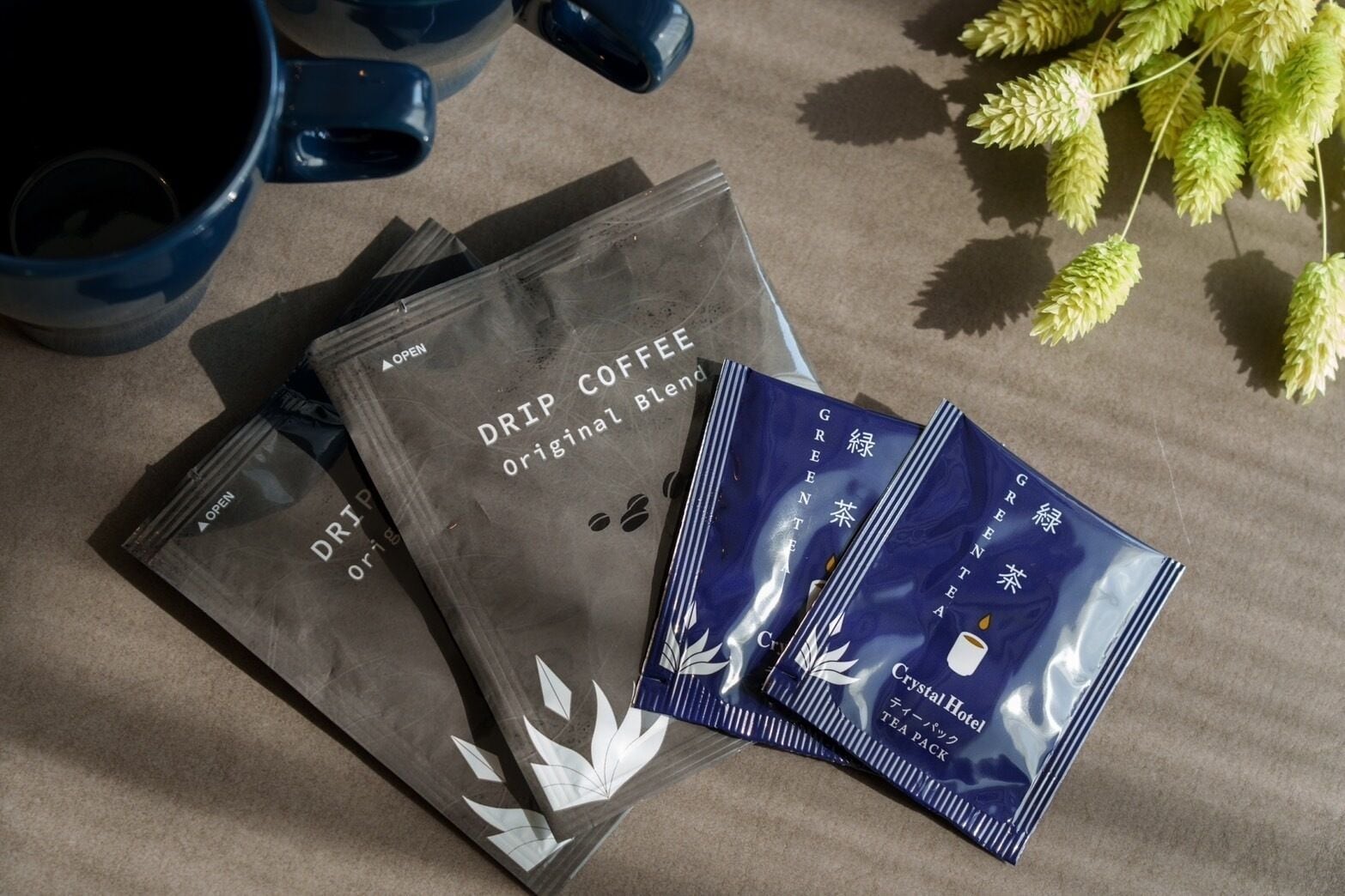 A tea set with a drip coffee bag and tea packets.