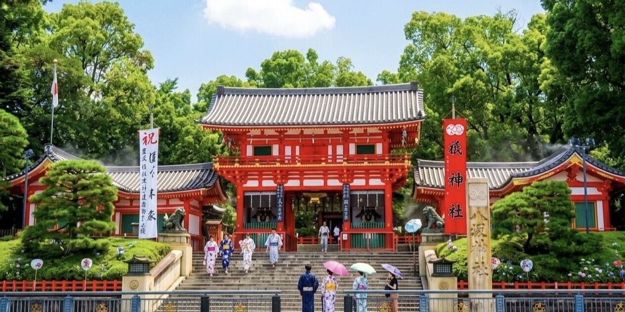 A traditional Japanese building with a red facade, a tiled roof, and a stone lantern in front.