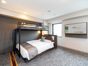 A bunk bed room with a bed, a window, and a wall-mounted screen displaying 'SuperHotel'. - Super Hotel Premier Aso Kumamoto Airport (Ozu)