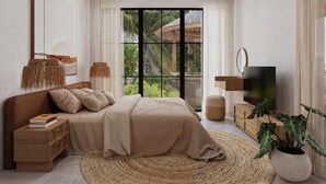 Een moderne slaapkamer met een groot bed, een televisie en uitzicht op groen.