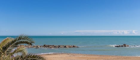 Enjoy a serene beach experience with calm waters and a picturesque shoreline.