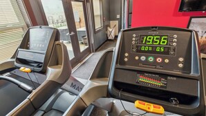 A treadmill with digital display, control panel, and safety features. - Modern Retreat Near Campus & Local Trails (Mansfield)