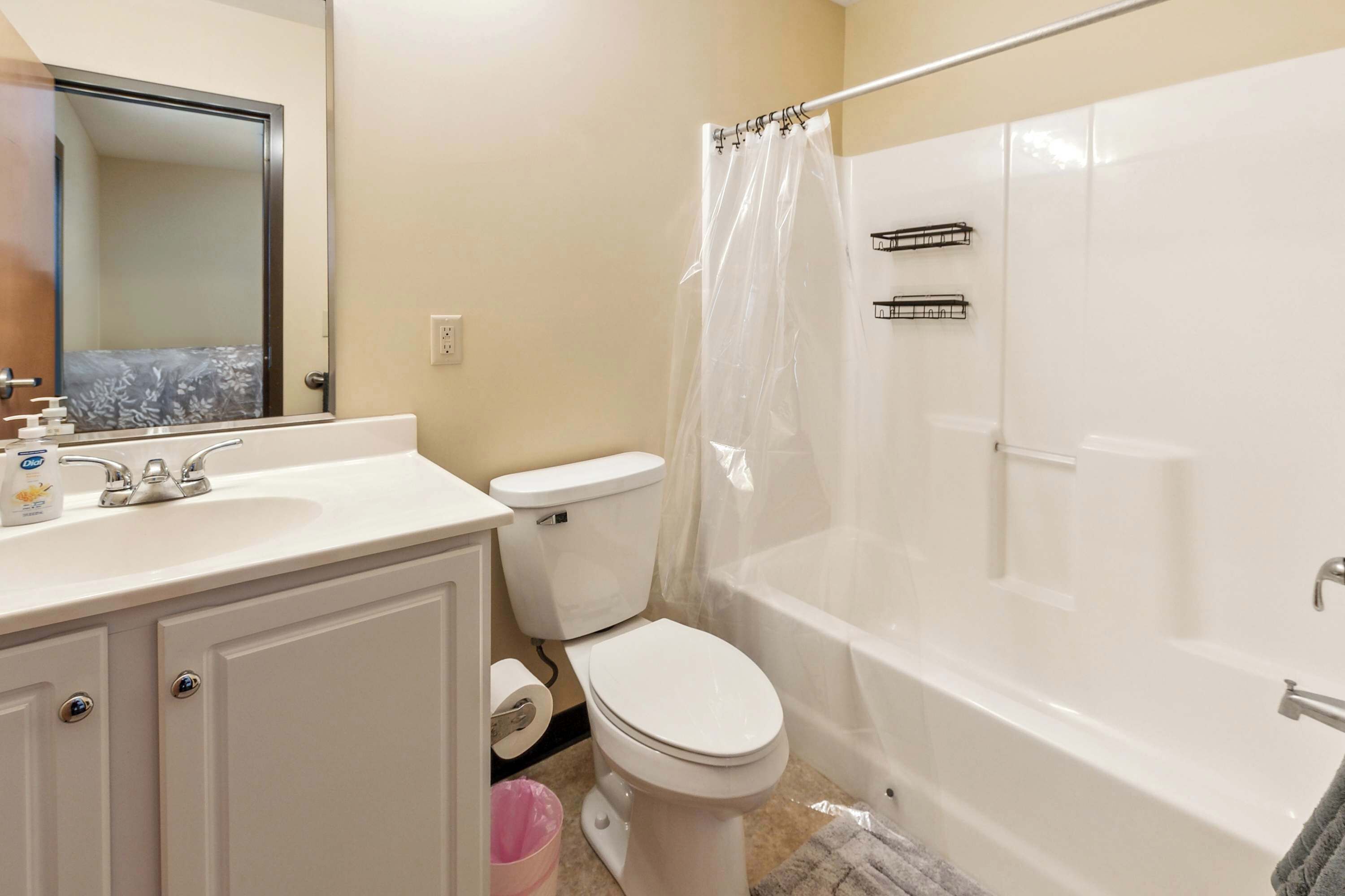 A bathroom with a toilet, sink, and bathtub.