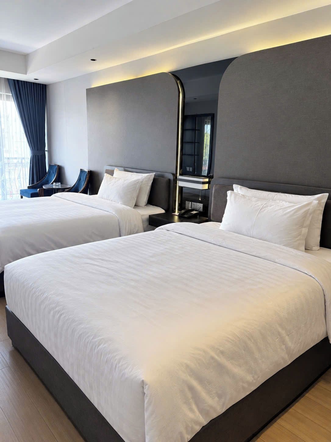 Una habitación de hotel con dos camas, un escritorio y una silla.