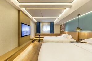 A hotel room with two beds, a TV mounted on the wall, a small table, and a window with curtains. - Jinglai Hotel (Shanghai Bund East Nanjing Road Pedestrian Street) (Shanghai)