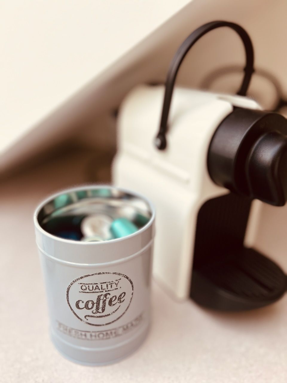 A coffee machine with a canister labeled "Quality Coffee" under it.