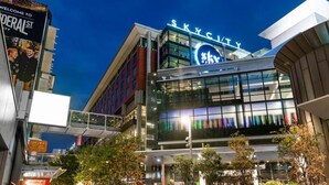 A modern building with a large illuminated sign reading "SKYS CITY".