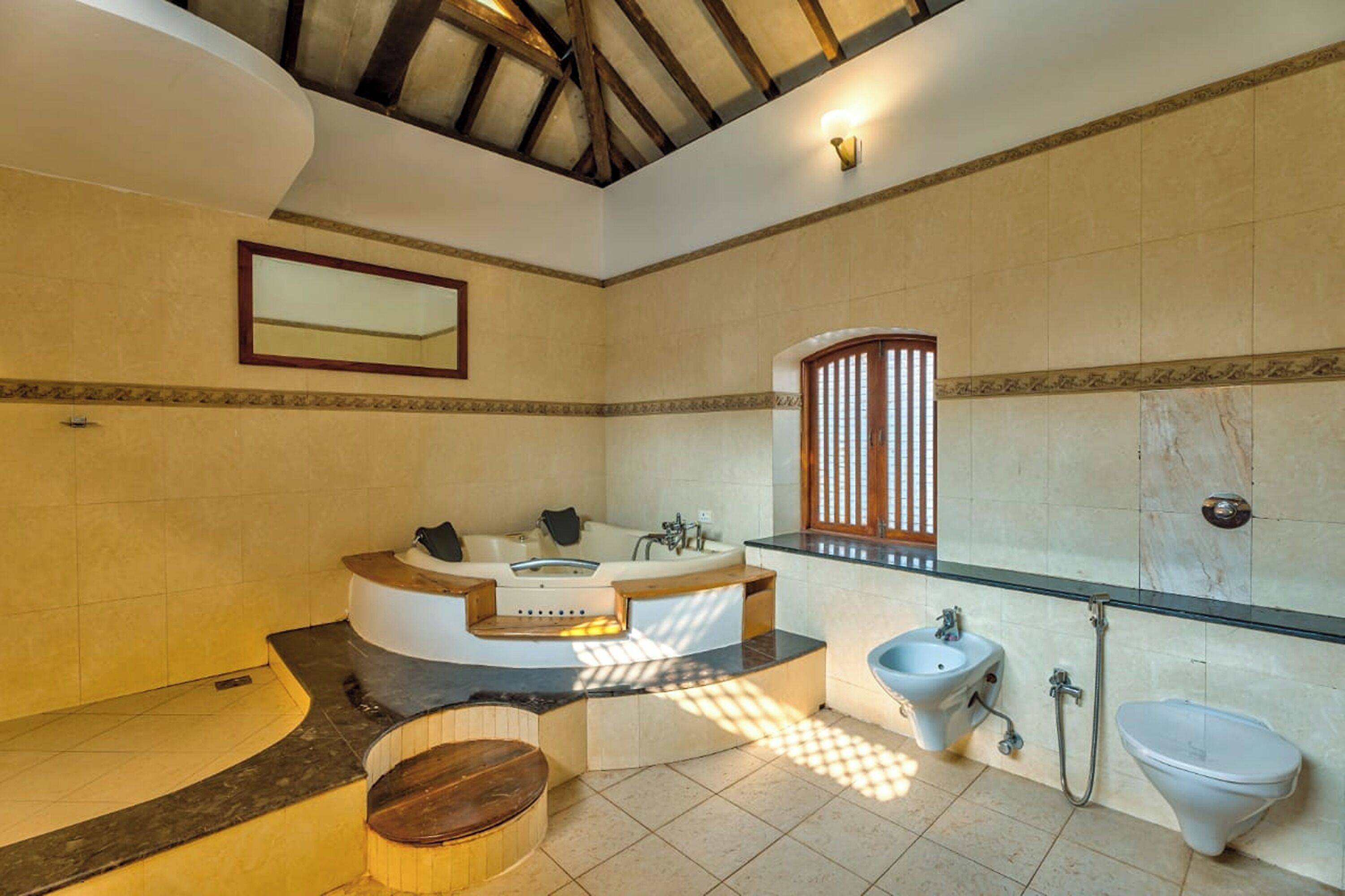 A spacious bathroom with a freestanding bathtub, a glass shower enclosure, and a large mirror.