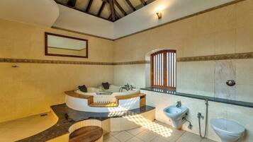 A spacious bathroom with a freestanding bathtub, a glass shower enclosure, and a large mirror.