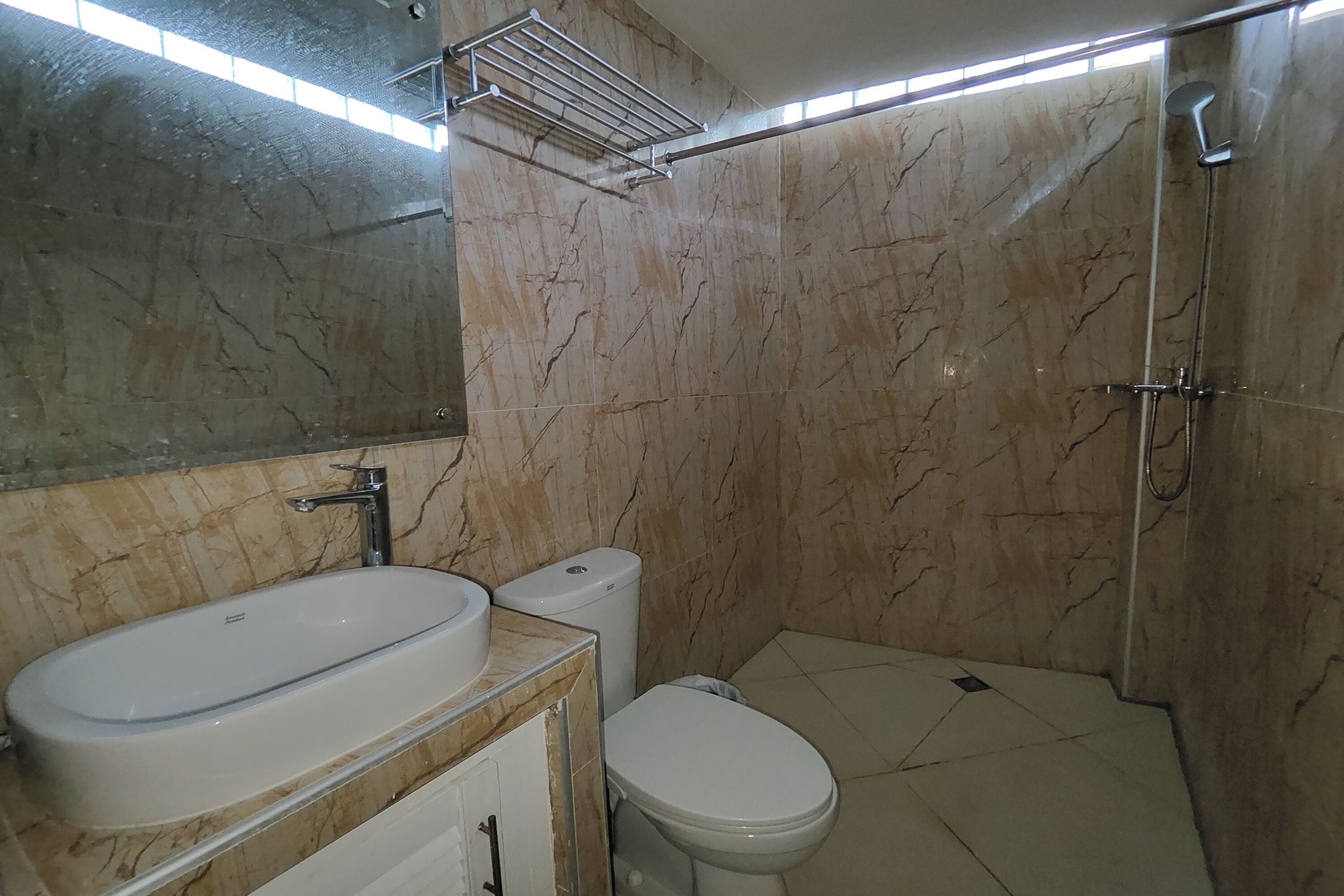 A bathroom with a bathtub, toilet, and a shower.