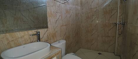 A bathroom with a bathtub, toilet, and a shower.