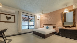 A bedroom with a bed, dresser, and a window with curtains. - Echor Avontade Pool Villas Anjuna Goa (Anjuna)