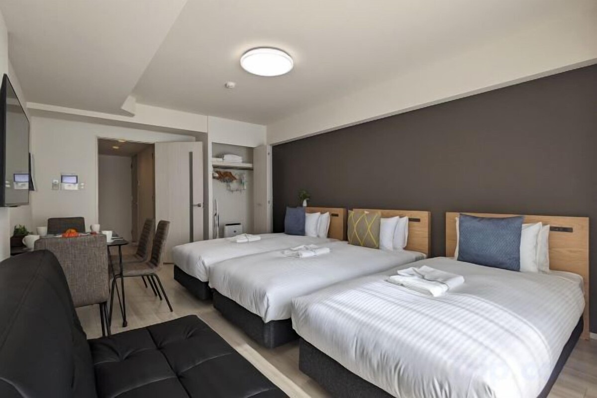 Premium bedding, laptop workspace, blackout drapes, soundproofing