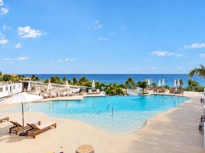 Relax by the infinity pool with stunning ocean views just steps from your suite/residence.